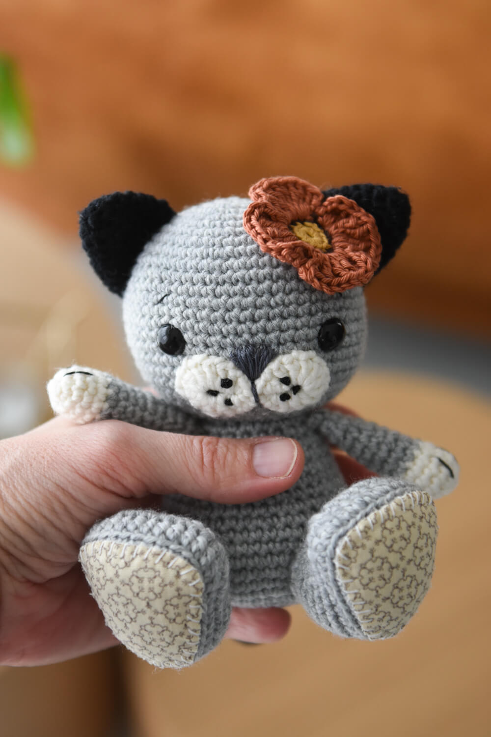 gray crochet kitten with poppy flower