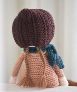 Crochet doll in a coat and bonnet