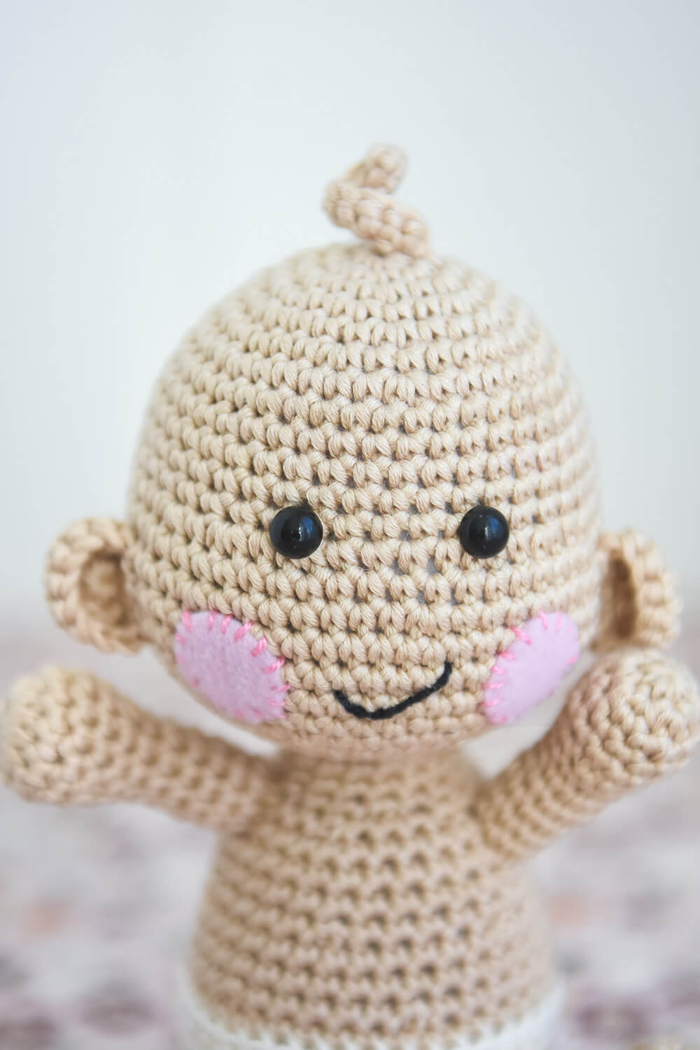 Crochet baby doll smiling